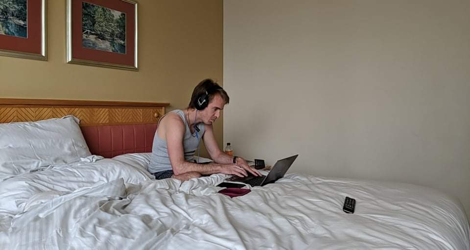Working on a laptop during hotel quarantine