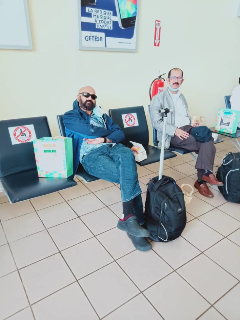 Rajesh and Rao waiting in departures at Malabo Airport